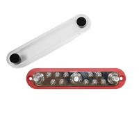 Overhead view of red busbar with three M10 studs, ten screws and detached clear cover