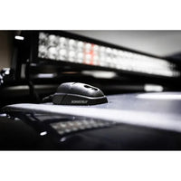 Cable seal installed on a 4WD roof in front of an active LED light bar at night