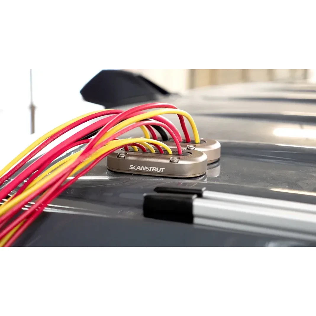 Two aluminium cable seals installed on a vehicle roof managing multiple wires