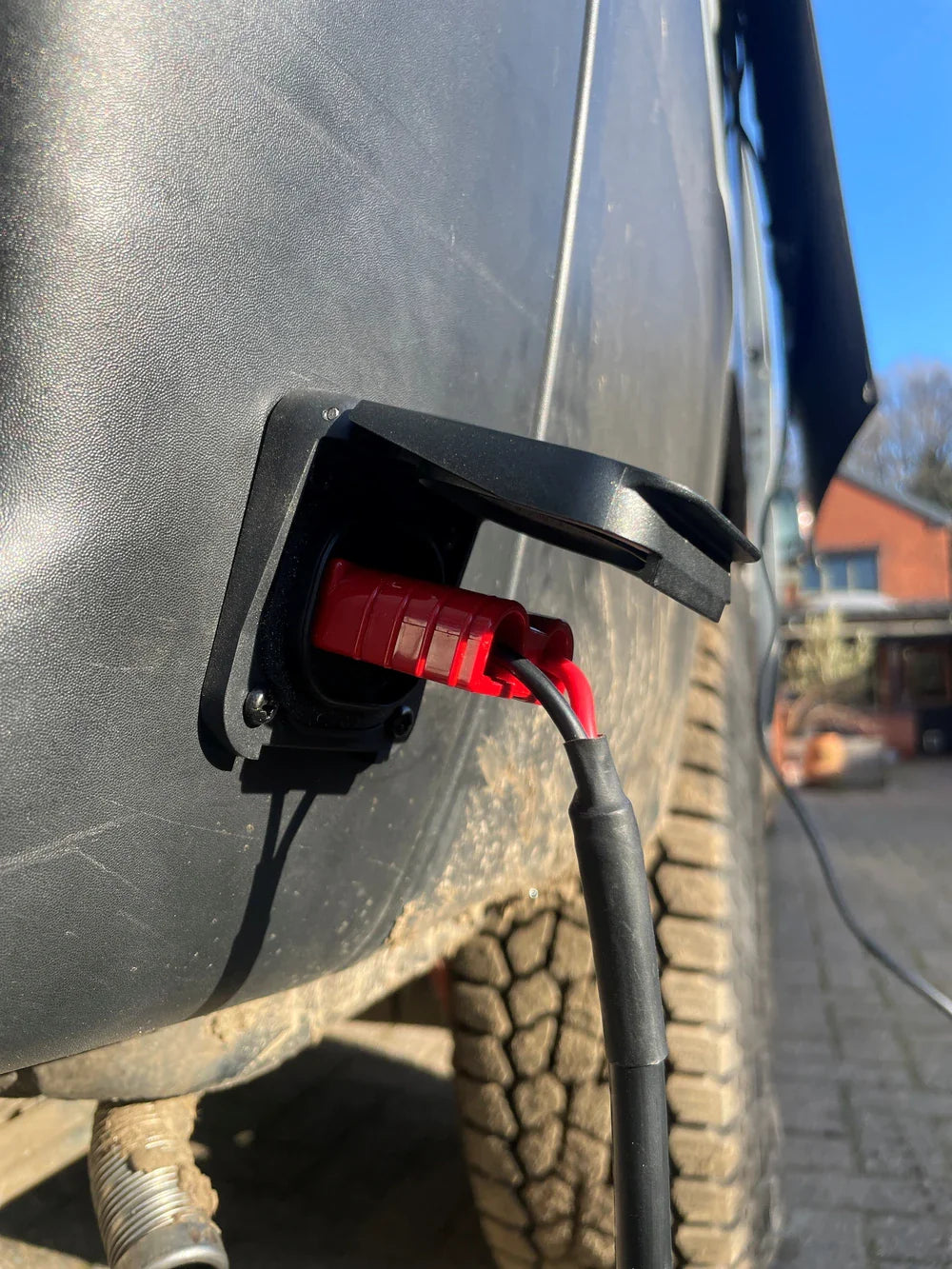 Red Anderson plug connected to a mounted Ventura solar socket on a vehicle