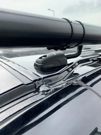 Scanstrut cable seal on a black vehicle roof routing protective conduit