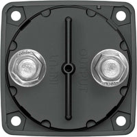 Rear housing of battery switch displaying two terminal studs, retaining nuts and molded input output markings