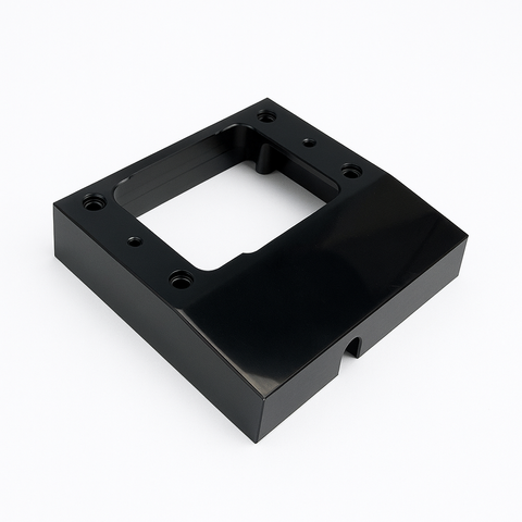 Black mounting spacer for 'C' type power outlets featuring a central cutout and side cable entry notch
