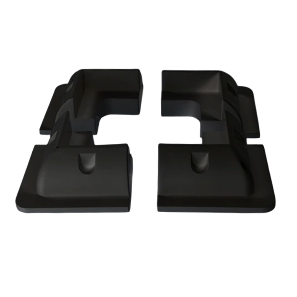 Four black ABS plastic solar panel corner brackets showing aerodynamic profile and internal mounting recesses