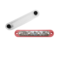 Red busbar with four studs and six screws, shown with its clear protective cover removed