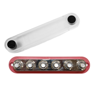Top-down view of red busbar with cover removed to show six M10 studs and mounting holes