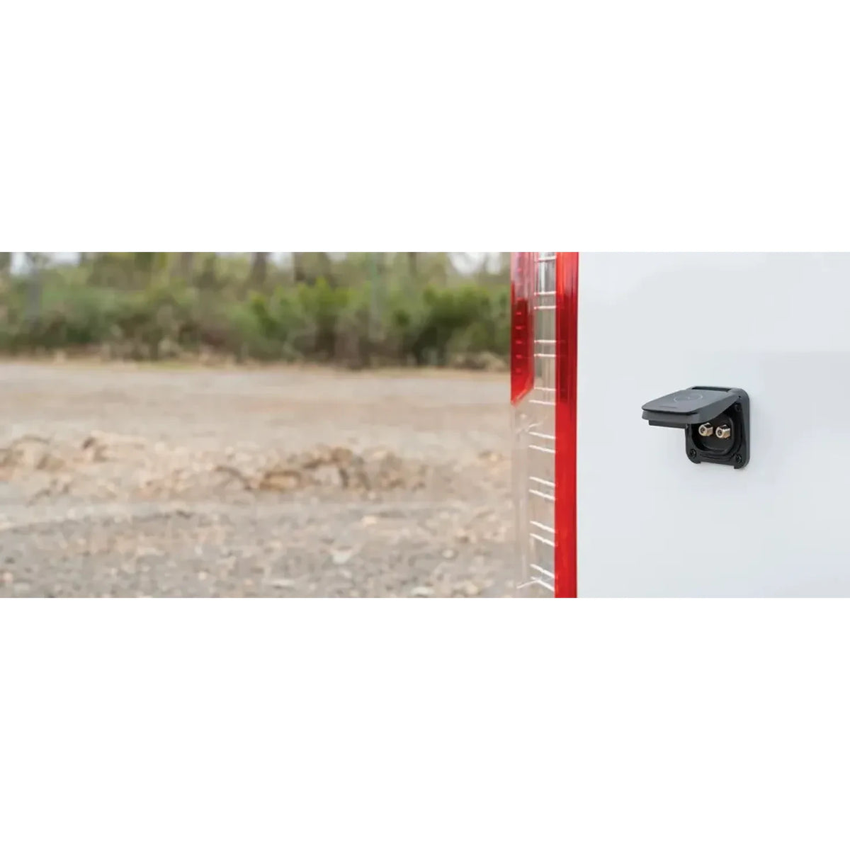 Waterproof TV socket mounted on the white exterior wall of a caravan