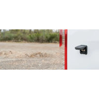 Waterproof TV socket mounted on the white exterior wall of a caravan