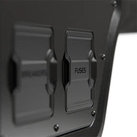 Close-up of protective black covers labelled Breakers and Fuses on the canopy power system
