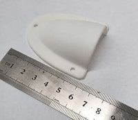 White clamshell cable entry cover positioned next to a metric ruler for scale