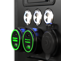 Close-up of two green illuminated 100W USB sockets and a 12V marine-grade cigarette socket