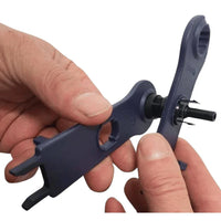 Close-up of hands using spanners to tighten a solar cable gland nut