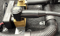 Black insulation cover installed on a negative battery terminal lug protecting the connection