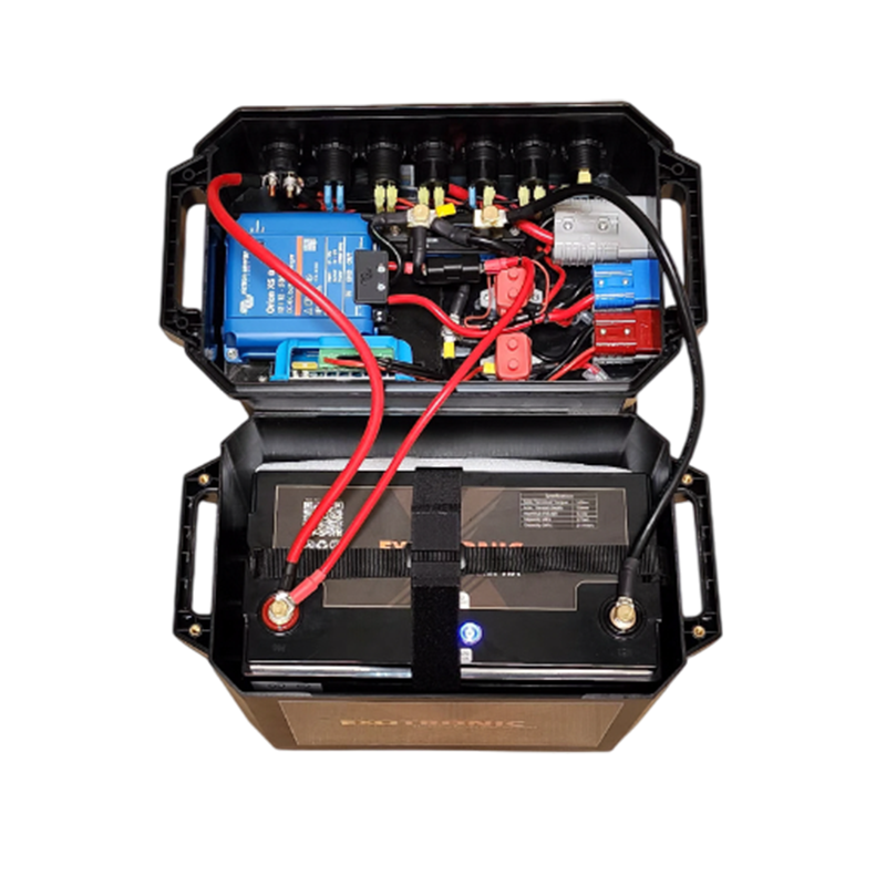 Open battery box lid revealing internal wiring, Victron Orion XS charger and circuit protection