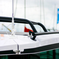 Grey cable seal installed on a white boat deck near black rails