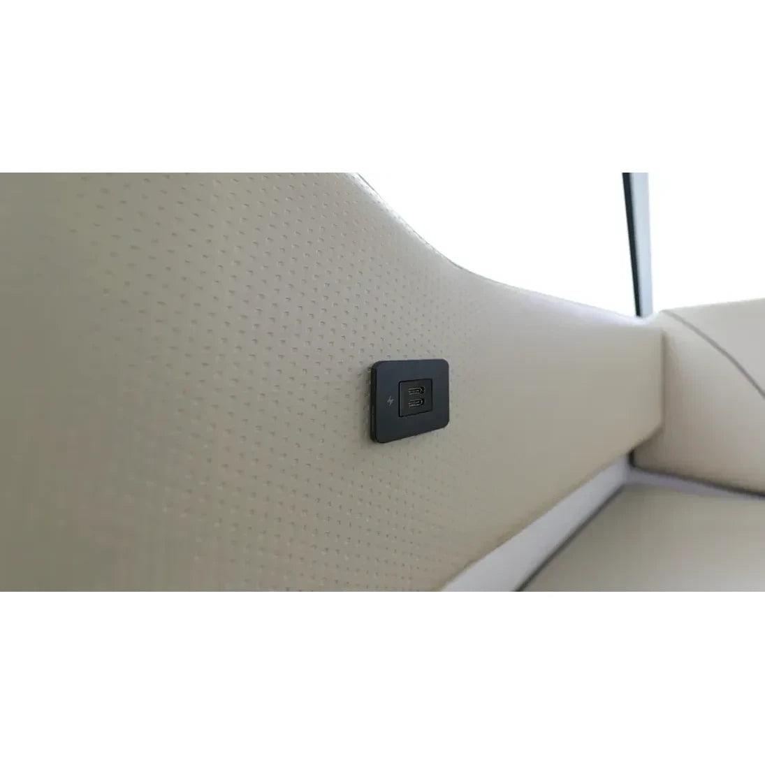 USB-C socket installed on a cream textured marine interior wall panel