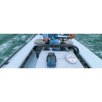 Lifestyle view of a smartphone charging in a marine-grade mount on a boat console