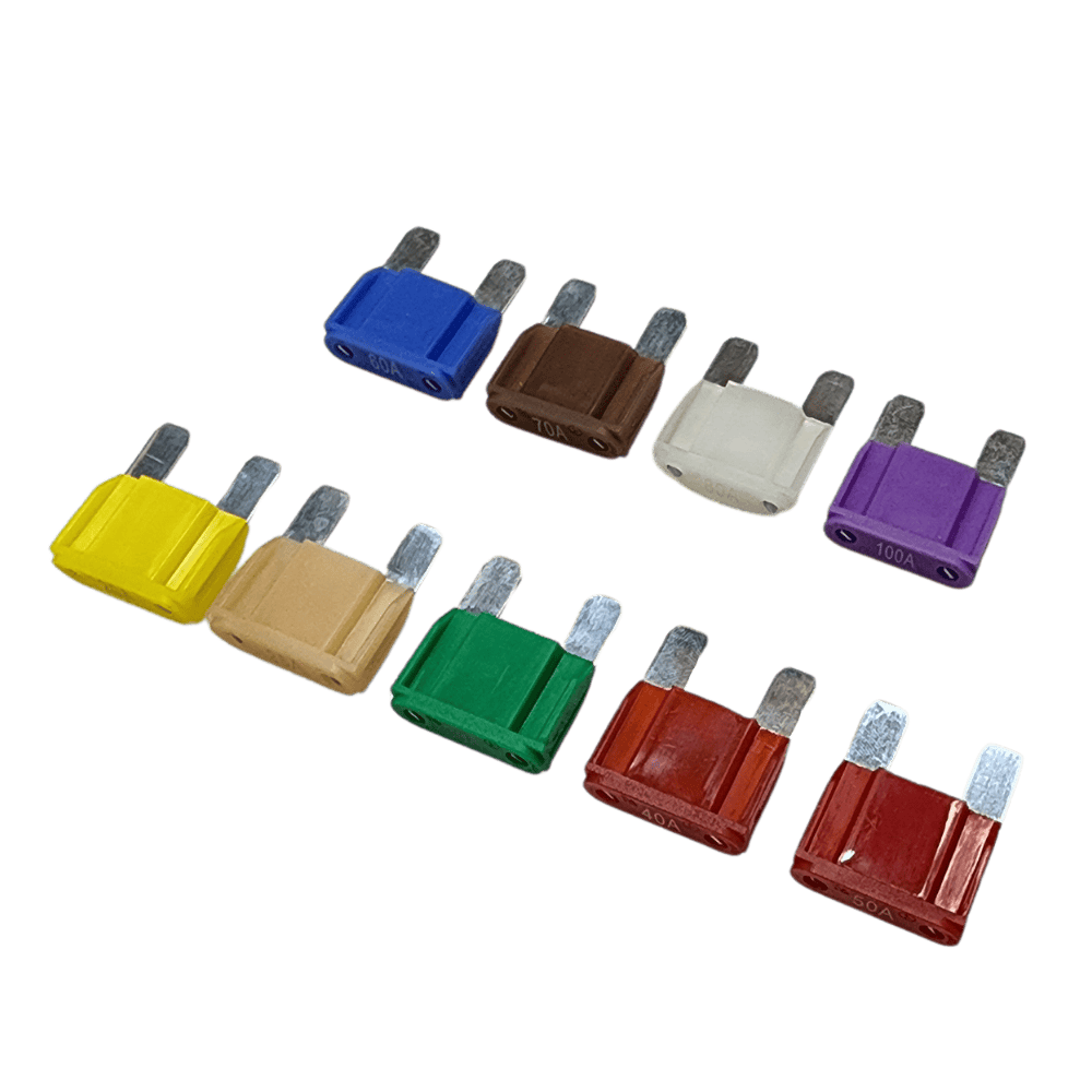 Group of colour-coded maxi blade fuses ranging from 20A to 100A laid out on a white background