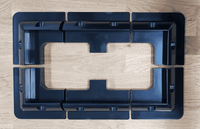 Overhead layout view of four corner brackets and two mid brackets arranged on a wooden surface