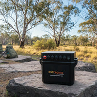 Portable lithium battery box on a rock at a remote Australian campsite