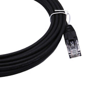 Close-up of black patch cord coil and single RJ45 plug with snagless clip protector