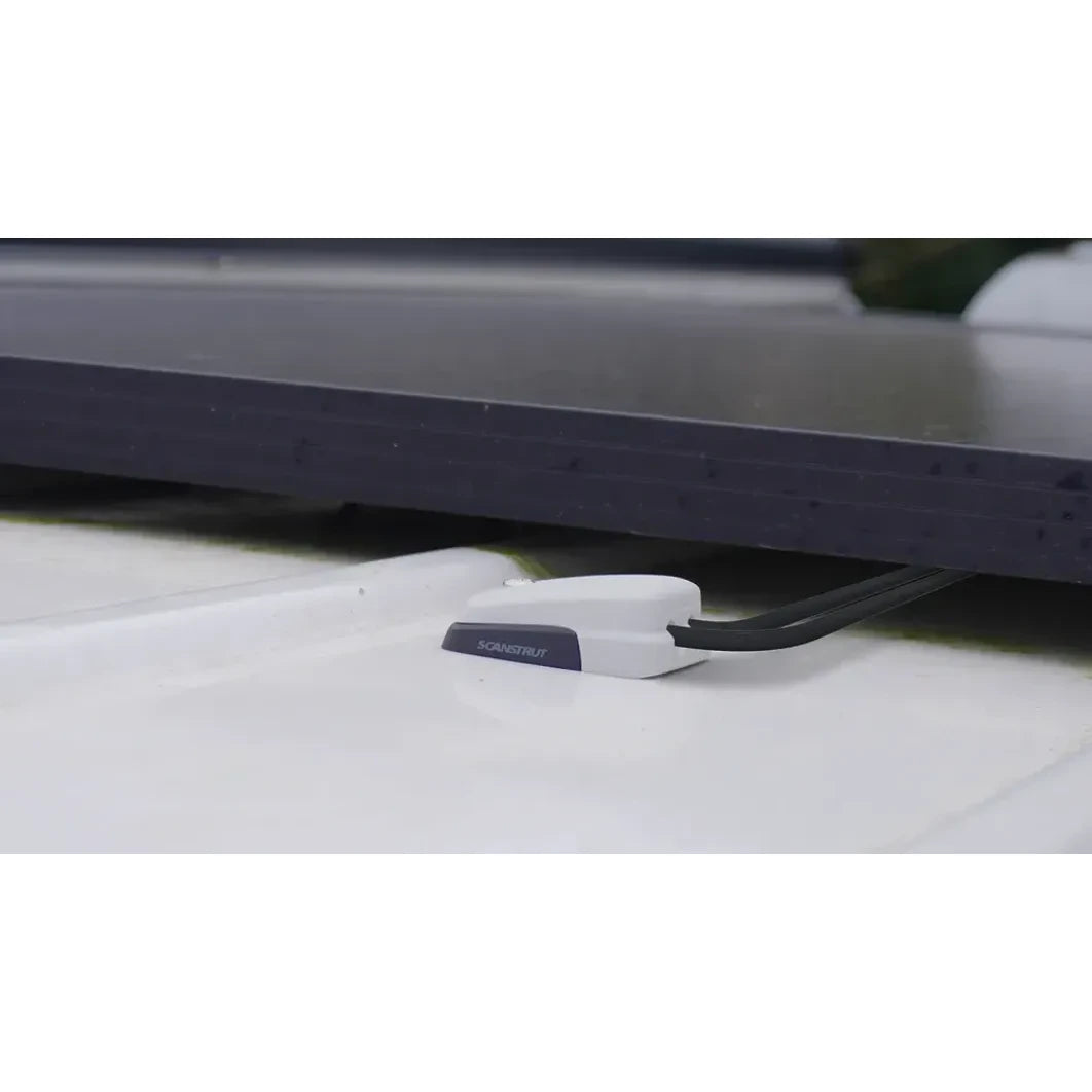 Low profile grey cable seal installed on a textured white roof surface