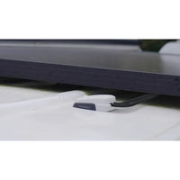 Low profile grey cable seal installed on a textured white roof surface