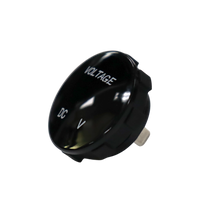 Angled front view of round black voltmeter gauge displaying VOLTAGE and DC V text