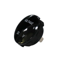 Angled front view of round black voltmeter gauge displaying VOLTAGE and DC V text