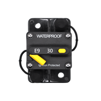 Top view of 30A waterproof circuit breaker with yellow reset lever and protective caps