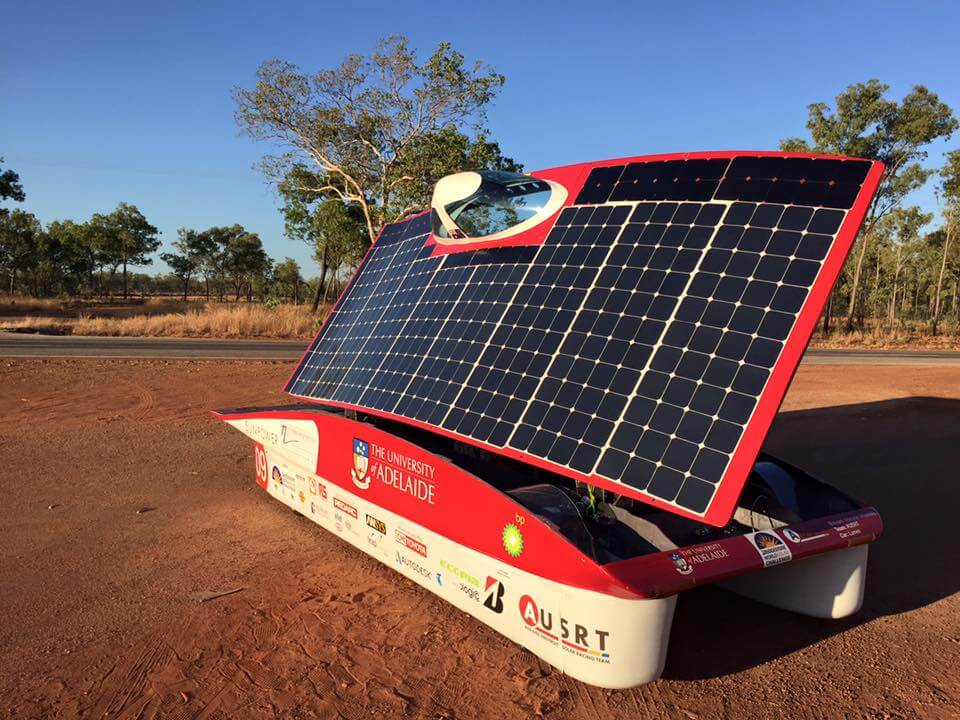 Pop-top motorhome with black flexible solar panel on front