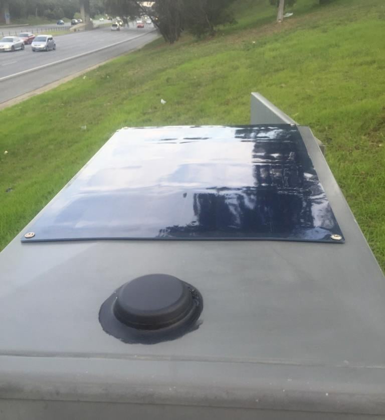 Black lightweight solar panel powering M2M monitoring on the Monash Freeway