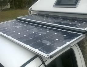 Pull-out tray with flexible solar panels on camper