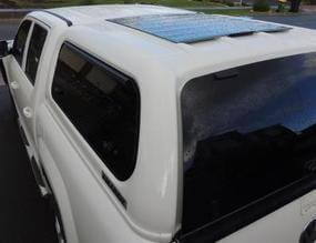 Twin-cab ute with thin lightweight low-profile black solar panel