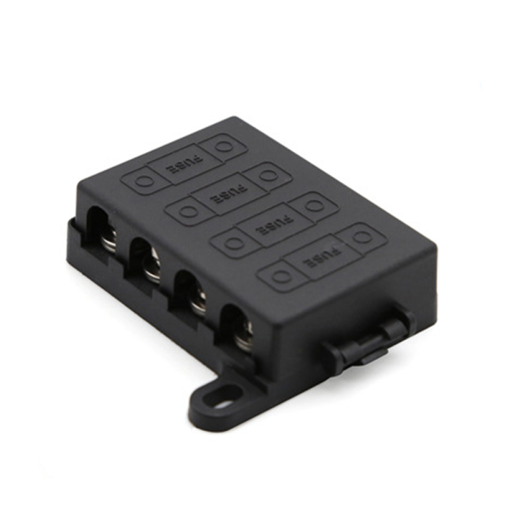 Angled view of black 4-way midi fuse holder with protective cover and mounting tabs