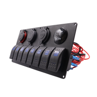 Angled view of black aluminium switch panel showing pre-wired harness and protective socket covers