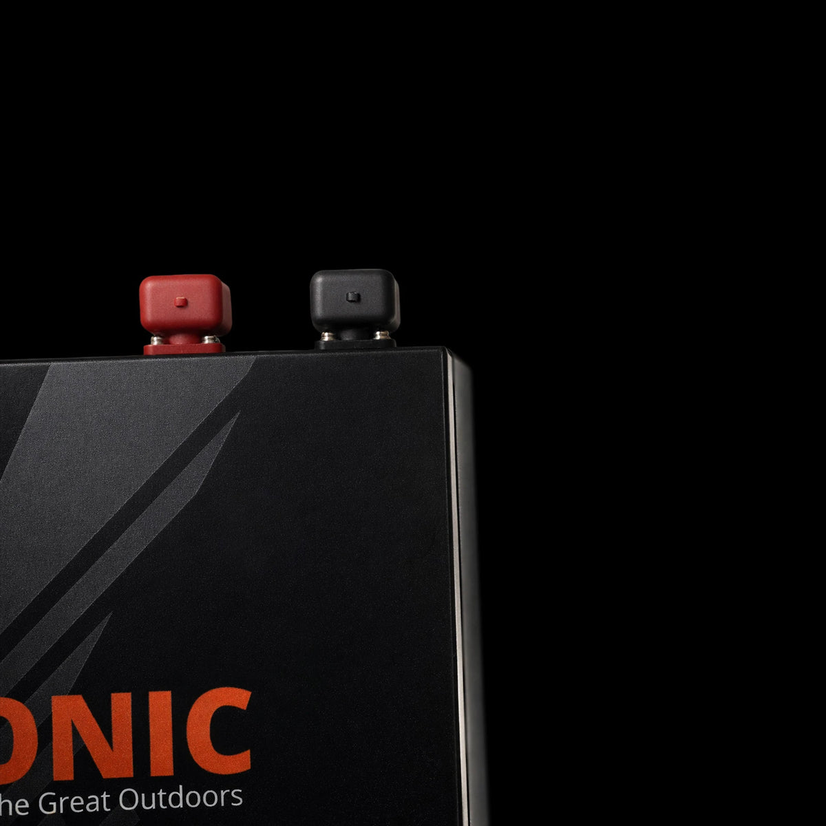 Close-up of red and black terminal protective caps on a lithium battery