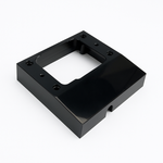 Black mounting spacer for 'C' type power outlets featuring a central cutout and side cable entry notch