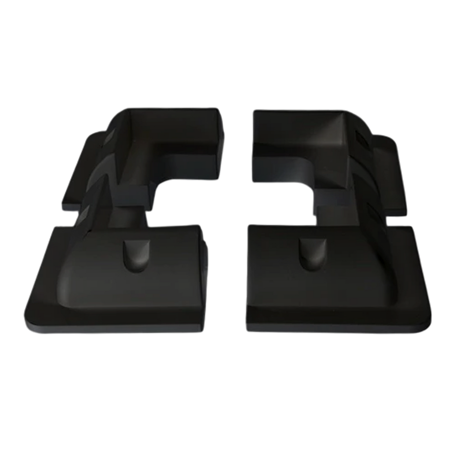 Four black ABS plastic solar panel corner brackets showing aerodynamic profile and internal mounting recesses
