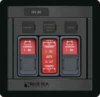 Marine control panel with three red rocker switches and sliding lockout covers for battery management