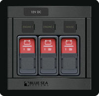 Blue Sea Panel 360 control lockout slides protecting three ML-Series switches on a marine electrical panel