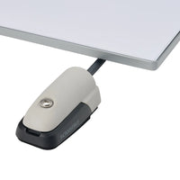 Cable seal installed on a white surface adjacent to a flat electronic panel