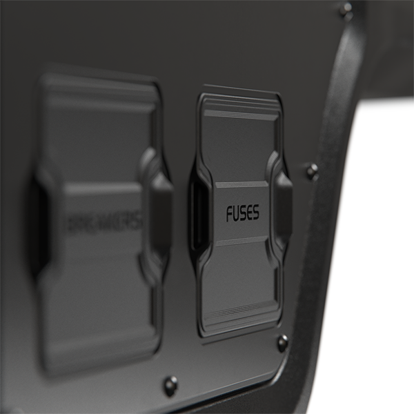 Close-up of protective black covers labelled Breakers and Fuses on the canopy power system