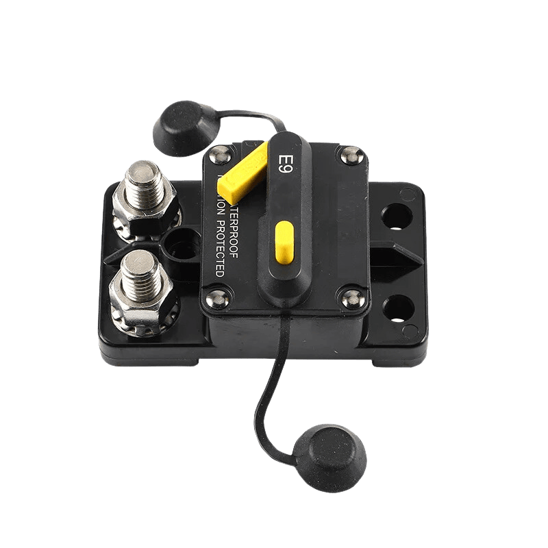 Angled view of circuit breaker terminals with protective caps removed exposing studs