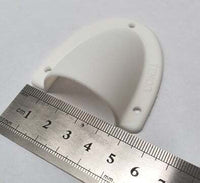 Front perspective of white clamshell cable cover with ruler showing width