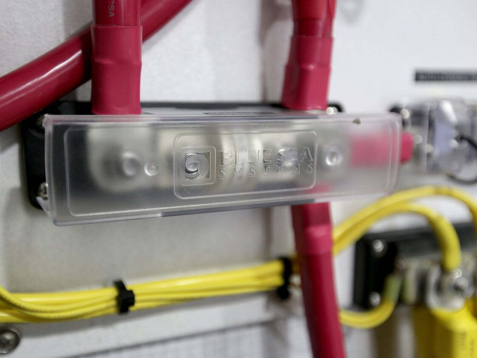 Installed Class T fuse block with red battery cables connected to terminals