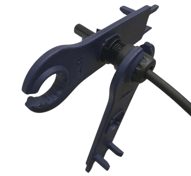 Two blue spanners interlocked on a solar connector illustrating the tightening mechanism