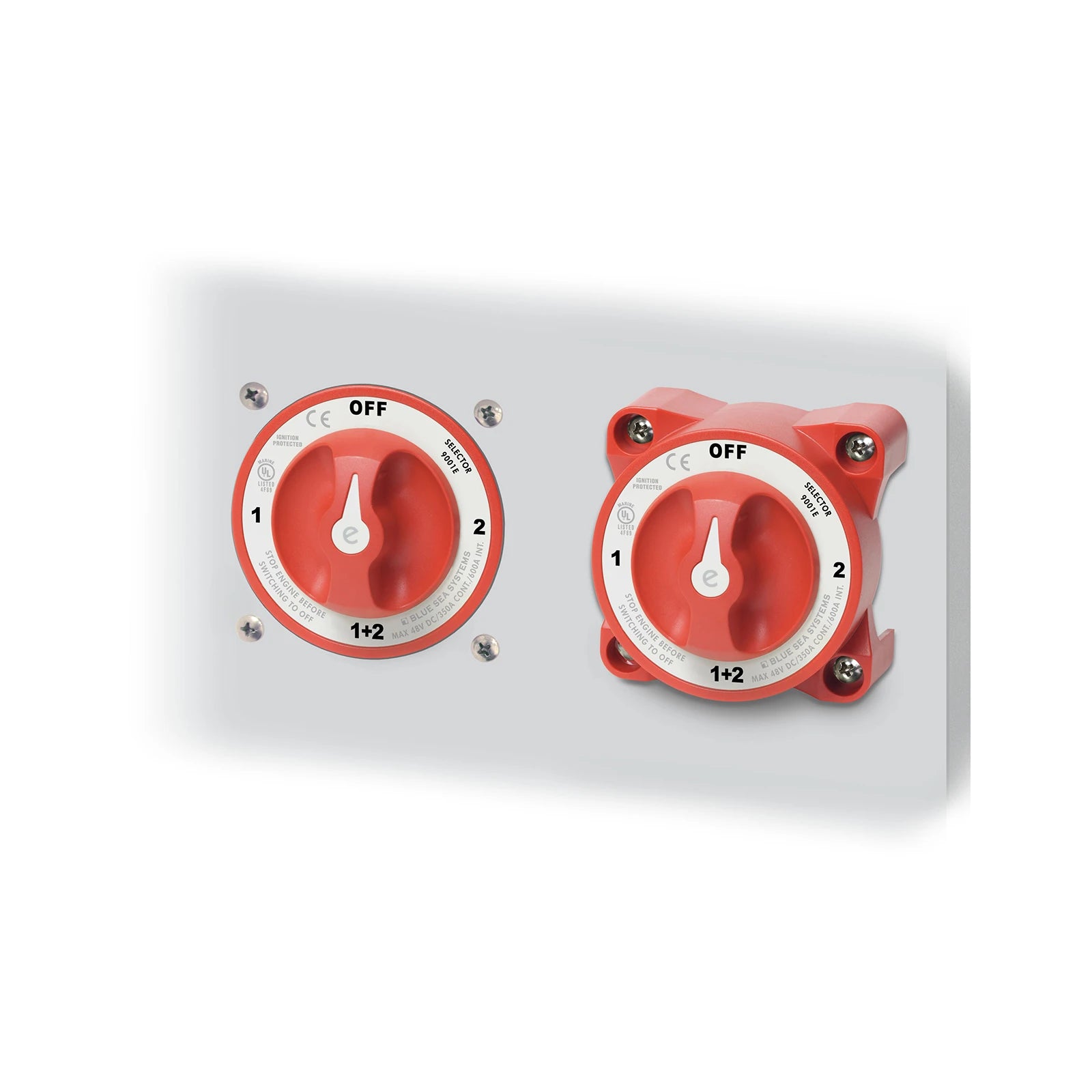 Two red battery switches showing flush and surface mounting methods on a grey panel