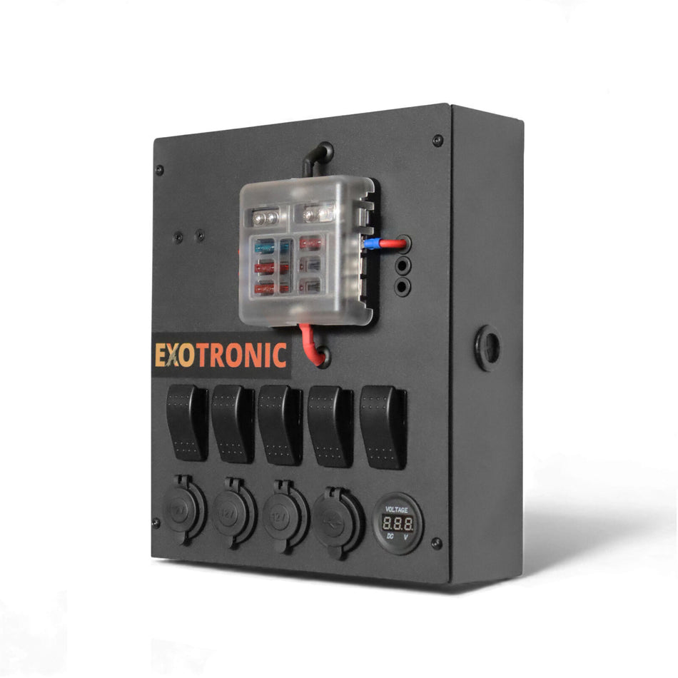 Angled view of black aluminium control hub featuring fuse block, switches, 12V sockets and digital voltmeter