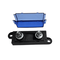 Exploded view of fuse holder showing detached blue cover and black base with dual threaded studs